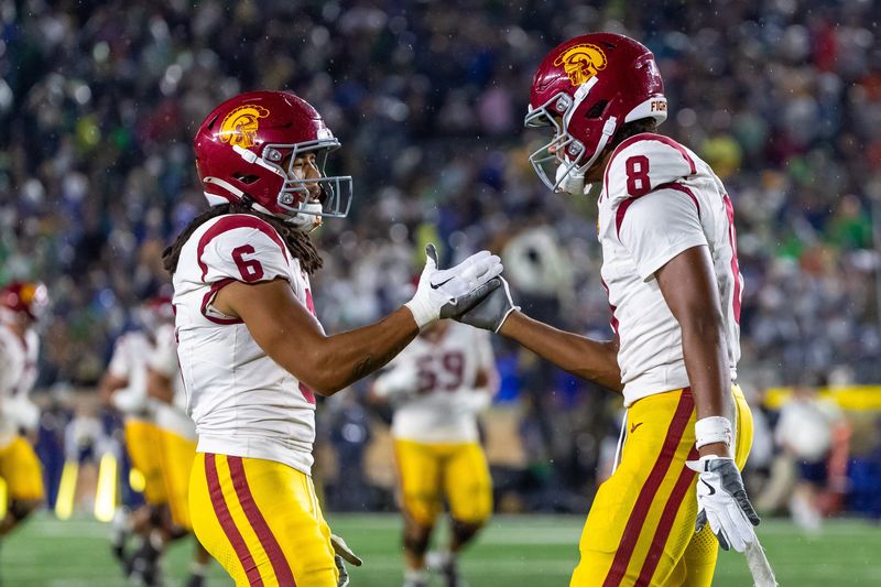 Oct 18, 2025; South Bend, Indiana, USA; Southern California Trojans wide receiver Ja'Kobi Lane (8) celebrates after scoring against the Notre Dame Fighting Irish with wide receiver Makai Lemon (6) during the second half at Notre Dame Stadium. Mandatory Credit: Michael Caterina-Imagn Images
