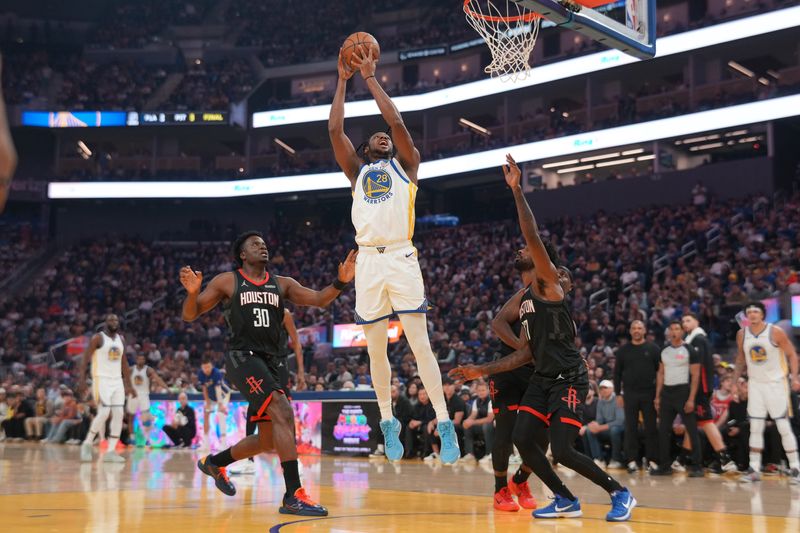 Apr 5, 2026; San Francisco, California, USA; Golden State Warriors center Charles Bassey (28) makes a shot between Houston Rockets center Clint Capela (30) and forward Tari Eason (17) in the first quarter at the Chase Center. Mandatory Credit: Cary Edmondson-Imagn Images