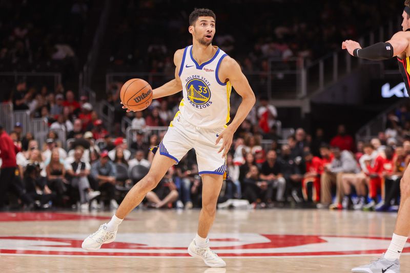 Mar 21, 2026; Atlanta, Georgia, USA; Golden State Warriors forward Malevy Leons (33) dribbles against the Atlanta Hawks in the fourth quarter at State Farm Arena. Mandatory Credit: Brett Davis-Imagn Images