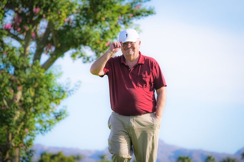 Larry Bohannan tips his cap after noticing the photographer taking his photo in Palm Desert, Calif., Nov. 5, 2025.
