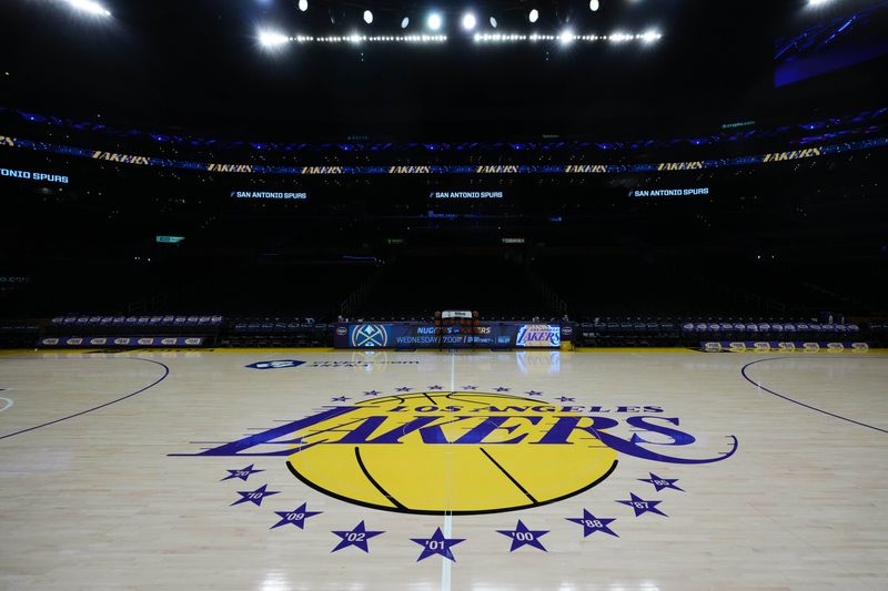 Mar 17, 2025; Los Angeles, California, USA; The Los Angeles Lakers logo at midcourt at Crypto.com Arena. Mandatory Credit: Kirby Lee-Imagn Images