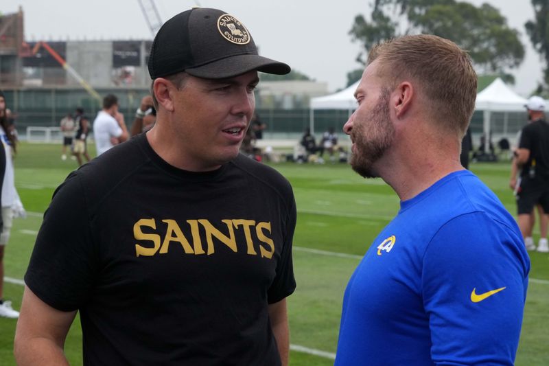 Aug 14, 2025; Carson, CA, USA; New Orleans Saints head coach Kellen Moore (left) talks with Los Angeles Rams head coach Sean McVay during a joint practice at the Dignity Health Sports Park. Mandatory Credit: Kirby Lee-Imagn Images
