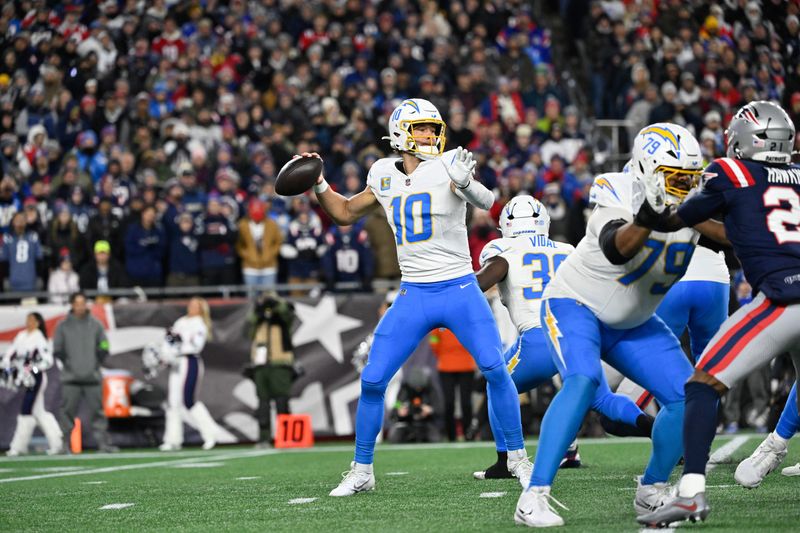 Jan 11, 2026; Foxborough, MA, USA; Los Angeles Chargers quarterback Justin Herbert (10) throws a pass during the first quarter against the New England Patriots in an AFC Wild Card Round game at Gillette Stadium. Mandatory Credit: Eric Canha-Imagn Images