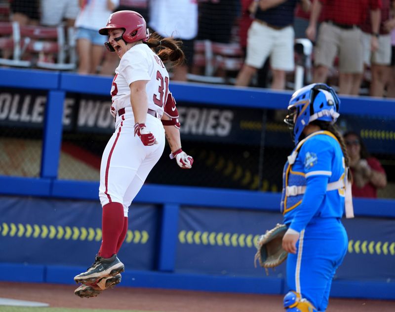 Alabama's Alexis Pupillo (31) celebrates a home run next to UCLA's Alexis Ramirez (28) in the fifth inning during a Women's College World Series softball game between the Alabama Crimson Tide and the UCLA Bruins at Devon Park in Oklahoma City, May 28, 2026.