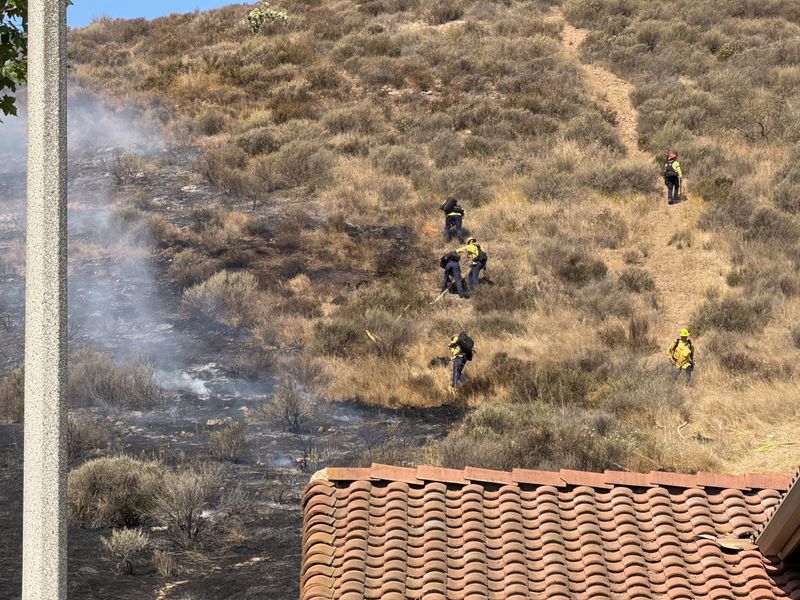 Firefighters tend to the Lesser Fire near Newbury Park High in Thousand Oaks on May 29, 2026 shortly after 9 a.m.