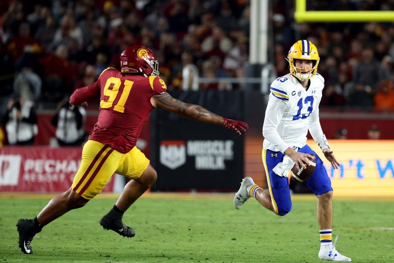 Nov 5, 2022; Los Angeles, California, USA; California Golden Bears quarterback Jack Plummer (13) and USC Trojans defensive lineman Brandon Pili (91) during the second quarter at United Airlines Field at Los Angeles Memorial Coliseum. Mandatory Credit: Kiyoshi Mio-USA TODAY Sports