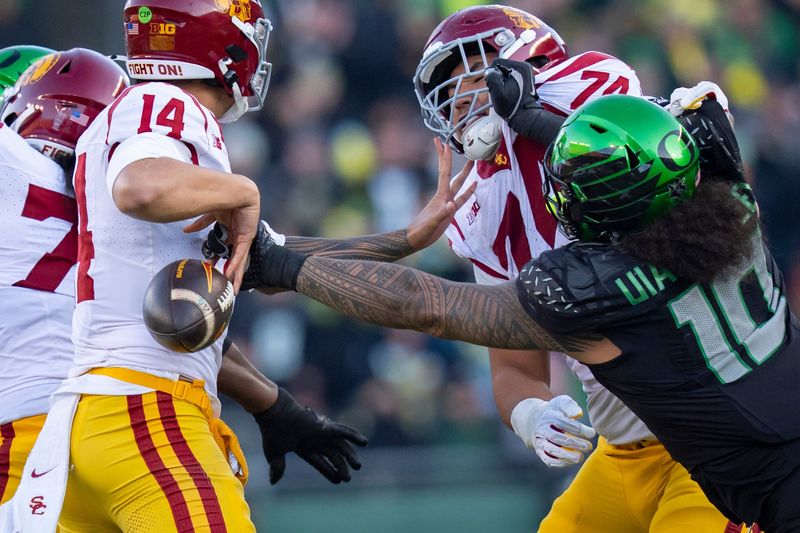 Oregon outside linebacker Matayo Uiagalelei, right, forces a fumble from USC quarterback Jayden Maiava as the Oregon Ducks host the USC Trojans on Nov. 22, 2025, at Autzen Stadium in Eugene, Oregon.