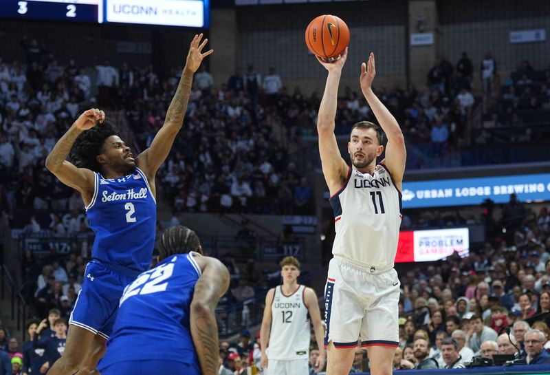 Feb 28, 2026; Storrs, Connecticut, USA; UConn Huskies forward Alex Karaban (11) shoots the ball against Seton Hall Pirates guard Tajuan Simpkins (2) in the first half at Harry A. Gampel Pavilion. Mandatory Credit: David Butler II-Imagn Images