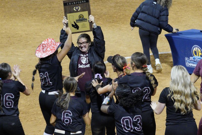 Head coach Lou Allan holds the plaque after the Riverside Prep softball team celebrates after winning the CIF-SS Div. 3 championship on Saturday, May 30.