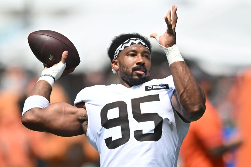 Jul 28, 2025; Berea, OH, USA; Cleveland Browns defensive end Myles Garrett (95) plays catch with fans during training camp at CrossCountry Mortgage Campus. Mandatory Credit: Ken Blaze-Imagn Images