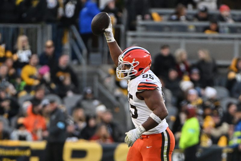 Dec 8, 2024; Pittsburgh, Pennsylvania, USA; Cleveland Browns defensive end Myles Garrett (95) celebrates a fumble recovery against the Pittsburgh Steelers during the fourth quarter at Acrisure Stadium. Mandatory Credit: Barry Reeger-Imagn Images