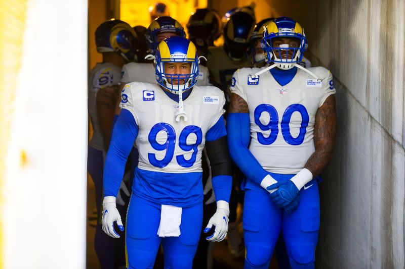 Jan 16, 2021; Green Bay, Wisconsin, USA; Los Angeles Rams defensive tackle Aaron Donald (99) and Michael Brockers (90) against Green Bay Packers during the NFC Divisional Round at Lambeau Field. Mandatory Credit: Mark J. Rebilas-USA TODAY Sports