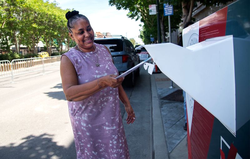 Voter Lecia Harrison places a ballot in a drop-off ballot box at the Registrar of Voters in front of the San Joaquin County Administration Building in Weber Avenue and San Joaquin Street in downtown Stockton.
