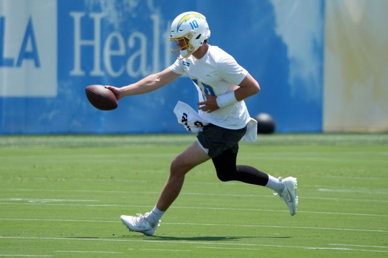 May 27, 2025; El Segundo, CA, USA; Los Angeles Chargers quarterback Justin Herbert (10) throws the ball during organized team activities at The Bolt. Mandatory Credit: Kirby Lee-Imagn Images