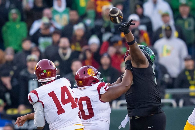 Oregon defensive lineman A'Mauri Washington blocks a pass by USC quarterback Jayden Maiava as the Oregon Ducks host the USC Trojans on Nov. 22, 2025, at Autzen Stadium in Eugene, Oregon.