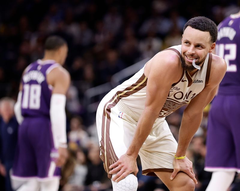 Jan 9, 2026; San Francisco, California, USA; Golden State Warriors guard Stephen Curry (30) smiles as a call is reviewed for a flagrant foul against Sacramento Kings guard Russell Westbrook (18) during the fourth quarter at Chase Center. Mandatory Credit: Kelley L Cox-Imagn Images