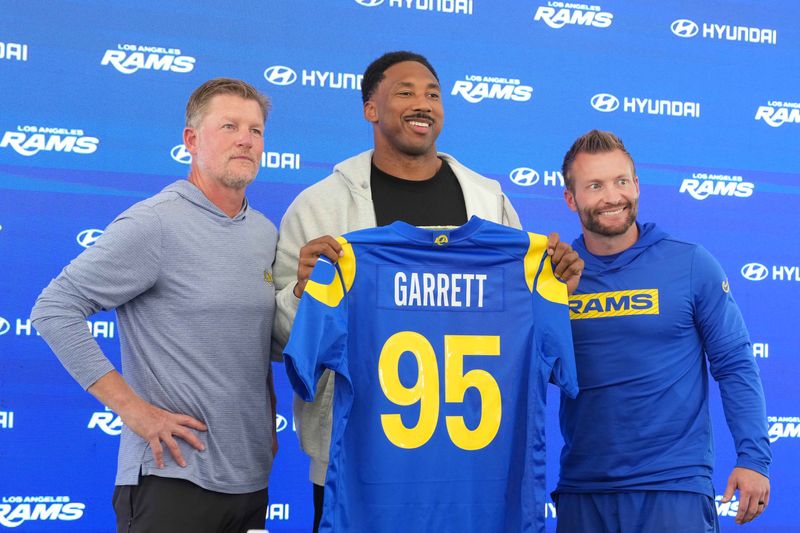 Jun 2, 2026; Woodland Hills, CA, USA; Los Angeles Rams defensive end Myles Garrett (95) poses with general manager Les Snead (left) and coach Sean McVay at press conference at Rams Practice Facility. Mandatory Credit: Kirby Lee-Imagn Images