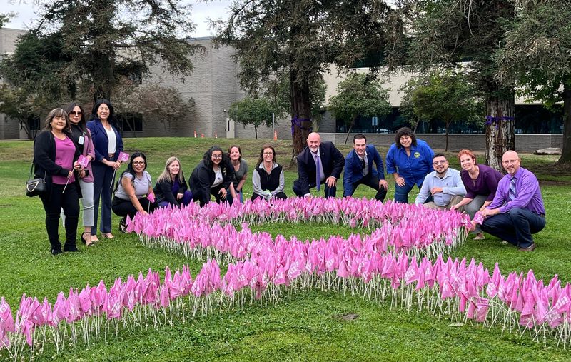 Tulare County Supervisors and Health & Human Services Department representatives plant flags to observe World Elder Abuse Awareness Month on May 26, 2026.