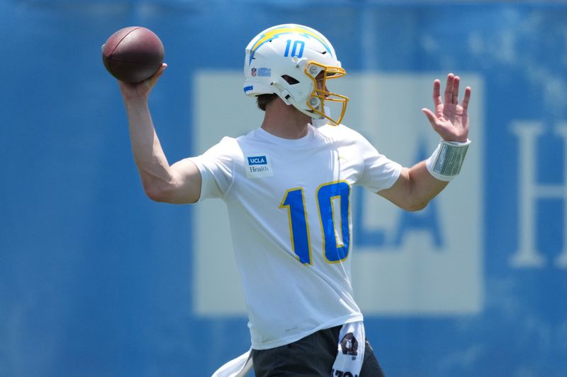 May 27, 2025; El Segundo, CA, USA; Los Angeles Chargers quarterback Justin Herbert (10) throws the ball during organized team activities at The Bolt. Mandatory Credit: Kirby Lee-Imagn Images