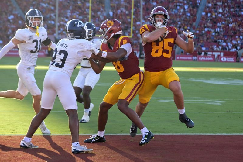 Sep 6, 2025; Los Angeles, California, USA; USC Trojans wide receiver Ja'Kobi Lane (8) sets a block on Georgia Southern Eagles defensive back Dorrian Smith (23) as USC Trojans tight end Walker Lyons (85) runs into the end zone for a touchdown during the first half at the Los Angeles Memorial Coliseum. Mandatory Credit: Jayne Kamin-Oncea-Imagn Images