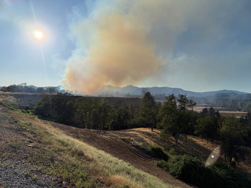 Smoke from the Quart Fire is seen in neighborhoods along Quartz Hill Road in Redding the evening of Saturday, June 6, 2026.
