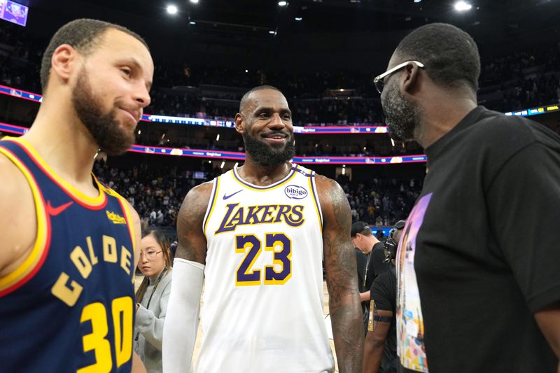Jan 25, 2025; San Francisco, California, USA; Los Angeles Lakers forward LeBron James (23) talks with Golden State Warriors guard Stephen Curry (30) and forward Draymond Green (right) after the game at Chase Center. Mandatory Credit: Darren Yamashita-Imagn Images