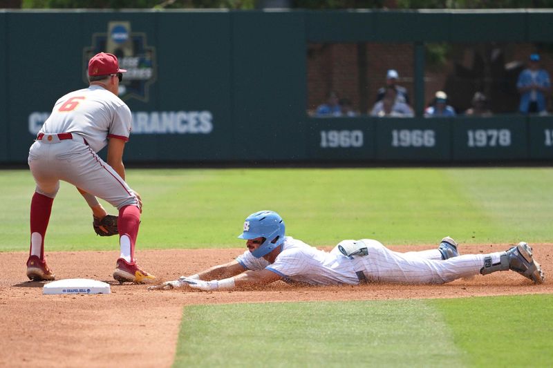 Jun 7, 2026; Chapel Hill, NC, USA; North Carolina Tar Heels infielder Gavin Gallaher (5) slides to take second base against USC Trojans infielder Dean Carpentier (6) during the first inning at Boshamer Stadium. Mandatory Credit: Zachary Taft-Imagn Images