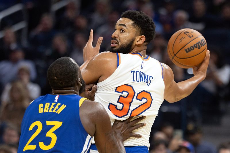 Jan 15, 2026; San Francisco, California, USA; New York Knicks center Karl-Anthony Towns (32) has the ball defended by Golden State Warriors forward Draymond Green (23) during the second quarter at Chase Center. Mandatory Credit: D. Ross Cameron-Imagn Images