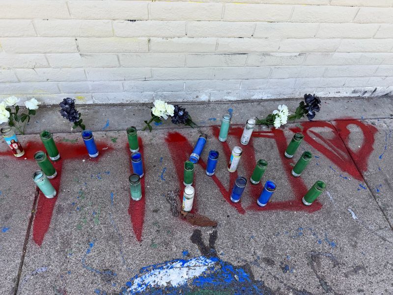 Candles, flowers and red writing that spell out "Tino" is visible on June 15, 2026 at Panella Park in Stockton. The memorial is in honor of 16-year-old Valentino Mark Gilmore who was shot and killed on June 13, 2026 in Hickock Court.
