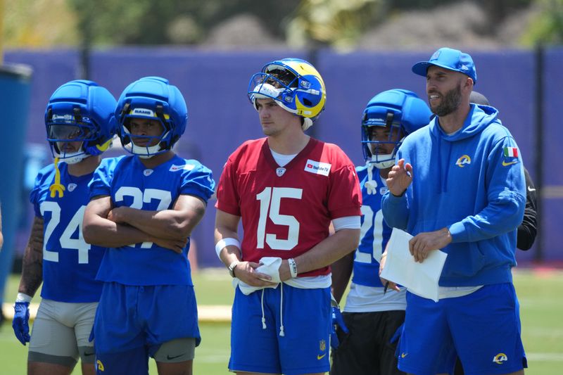 Jun 2, 2026; Woodland Hills, CA, USA; Los Angeles Rams running backs Blake Corum (24), Jarquez Hunter (27), quarterback Ty Simpson (15) and quarterbacks coach Dave Ragone watch during organized team activities at Rams Practice Facility. Mandatory Credit: Kirby Lee-Imagn Images