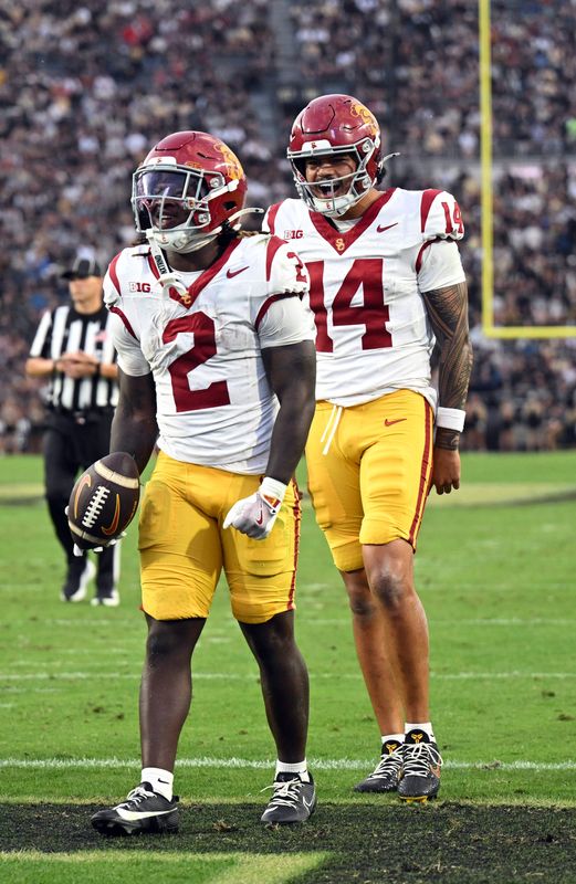 Sep 13, 2025; West Lafayette, Indiana, USA; USC Trojans running back Waymond Jordan (2) and USC Trojans quarterback Jayden Maiava (14) celebrate a touchdown during the second quarter against the Purdue Boilermakers at Ross-Ade Stadium. Mandatory Credit: Marc Lebryk-Imagn Images