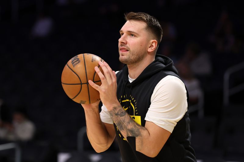 Jan 4, 2026; Los Angeles, California, USA;  Los Angeles Lakers forward/guard Luka Doncic (77) warms up before the game against the Memphis Grizzlies at Crypto.com Arena. Mandatory Credit: Kiyoshi Mio-Imagn Images