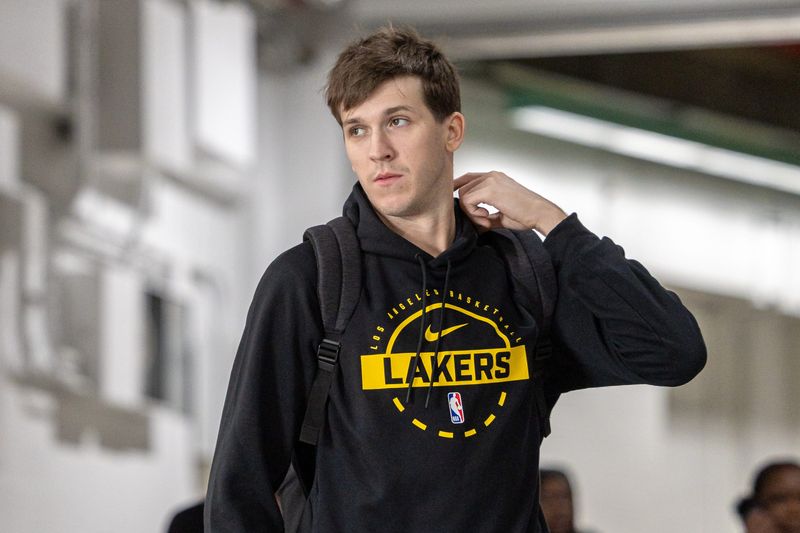 Nov 14, 2025; New Orleans, Louisiana, USA;  Los Angeles Lakers guard Austin Reaves (15) arrives at the arena before the game against the New Orleans Pelicans at Smoothie King Center. Mandatory Credit: Stephen Lew-Imagn Images