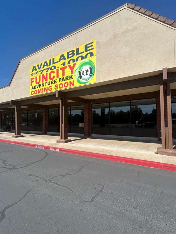 A banner on the front of the old Raley's store on Hartnell Avenue on June 17, 2026, announces a Fun City Adventure Park. Work on the new business has yet to start.