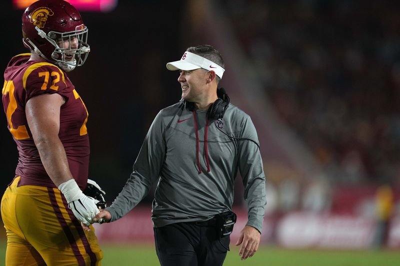 Sep 17, 2022; Los Angeles, California, USA; Southern California Trojans head coach Lincoln Riley and offensive lineman Andrew Vorhees (72) react in the second half against the Fresno State Bulldogs at United Airlines Field at Los Angeles Memorial Coliseum. Mandatory Credit: Kirby Lee-USA TODAY Sports