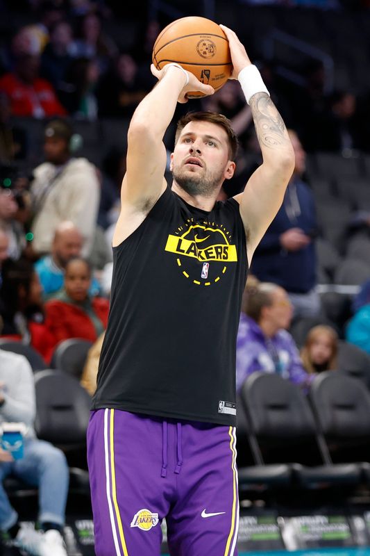 Nov 10, 2025; Charlotte, North Carolina, USA; Los Angeles Lakers forward/guard Luka Doncic (77) warms up prior to the game against the Charlotte Hornets at Spectrum Center. Mandatory Credit: Brian Westerholt-Imagn Images