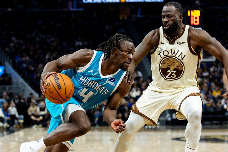 Jan 17, 2026; San Francisco, California, USA; Charlotte Hornets guard Sion James (4) drives past Golden State Warriors forward Draymond Green (23) during the fourth quarter at Chase Center. Mandatory Credit: John Hefti-Imagn Images
