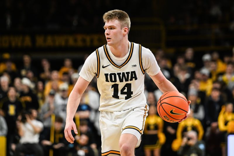 Jan 28, 2026; Iowa City, Iowa, USA; Iowa Hawkeyes guard Bennett Stirtz (14) controls the ball against the Southern California Trojans during the second half at Carver-Hawkeye Arena. Mandatory Credit: Jeffrey Becker-Imagn Images