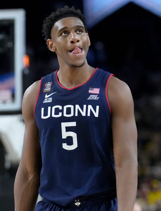 UConn Huskies forward Tarris Reed Jr. (5) walks off the court as time ticks off the clock Monday, April 6, 2026, during the NCAA menâ€™s basketball national championship game against the Michigan Wolverines at Lucas Oil Stadium in Indianapolis.
