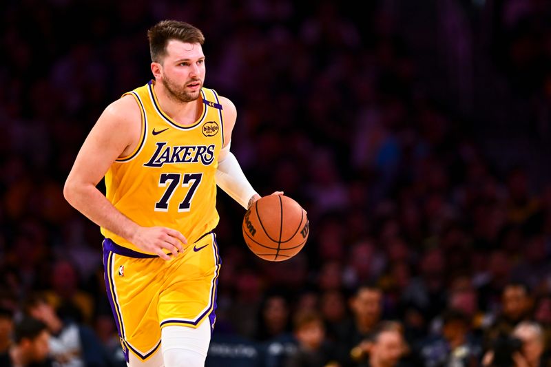 Apr 11, 2025; Los Angeles, California, USA; Los Angeles Lakers guard Luka Doncic (77) moves the ball against the Houston Rockets during the first half at Crypto.com Arena. Mandatory Credit: Jonathan Hui-Imagn Images