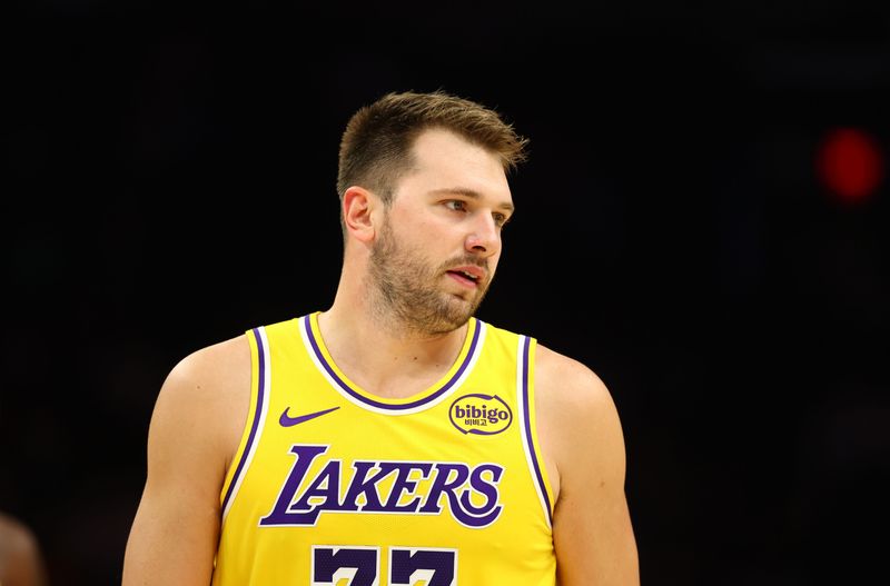 Oct 14, 2025; Phoenix, Arizona, USA; Los Angeles Lakers guard Luka Doncic (77) against the Phoenix Suns during an NBA preseason game at Mortgage Matchup Center. Mandatory Credit: Mark J. Rebilas-Imagn Images