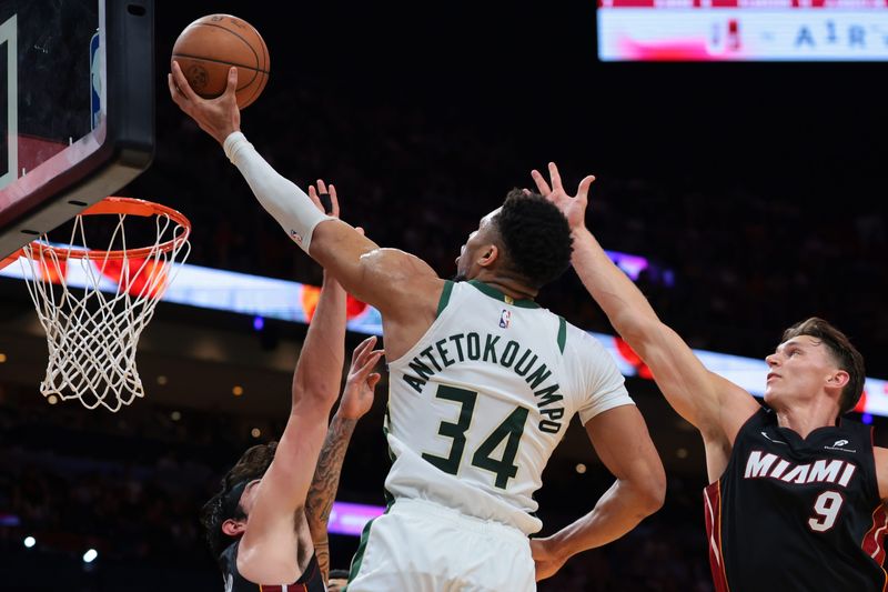 Mar 12, 2026; Miami, Florida, USA;  Milwaukee Bucks forward Giannis Antetokounmpo (34) drives to the basket against Miami Heat guard Pelle Larsson (9) and forward Jaime Jaquez Jr. (11) during the second quarter at Kaseya Center. Mandatory Credit: Sam Navarro-Imagn Images