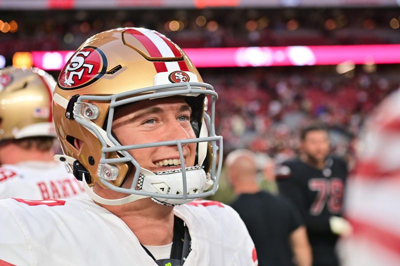 Nov 16, 2025; Glendale, Arizona, USA; San Francisco 49ers quarterback Mac Jones (10) looks on after defeating the Arizona Cardinals at State Farm Stadium. Mandatory Credit: Matt Kartozian-Imagn Images