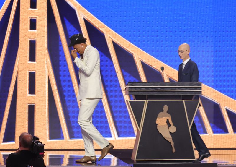Jun 23, 2026; New York, NY, USA; NBA commissioner Adam Silver greets the eleventh pick in the 2026 NBA draft, Michigan forward Yaxel Lendeborg after he was selected by the Golden State Warriors at Barclays Center. Mandatory Credit: Brad Penner-Imagn Images