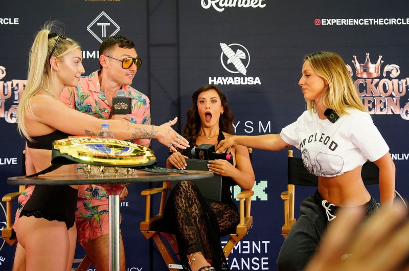 Main event boxers Britt Fit, left, and Rebecca McLeod give a handshake agreement to a six figure bet on themselves to win the fight during the official weigh-in for the Knockout Queen sanctioned women's boxing event as Dave Schmo and Amber Fields emcee the event in Indio, Calif., June 23, 2026.