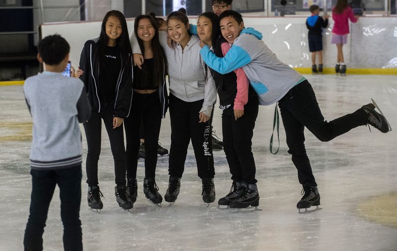 Cousins Kalia Lee, 13, left, Susan Yang, 15, Leanna Lee, 17, Natalie Lee, 13, and Kyle Lee, 17, pose for a picture taken by fellow cousin C.J. Chang, 13, as they seek refuge from the heat by taking in an open skate session at Oak Park Ice Arena in Stockton on July 30, 2018.