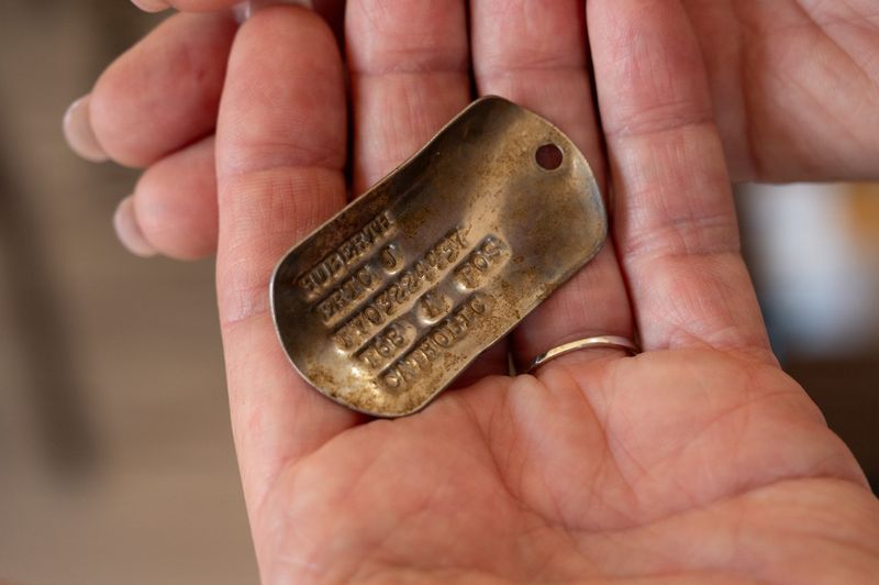Suzanne Huberth holds her brother's dog tags in a reunification ceremony on May 13. The identification for Air Force Capt. Eric Huberth was found 56 years after the Thousand Oaks man was declared missing in action in the Vietnam War.