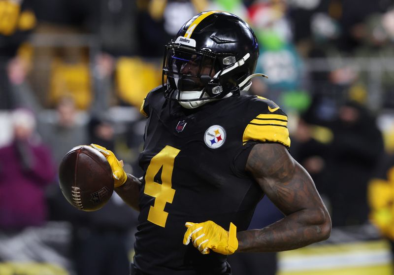Dec 15, 2025; Pittsburgh, Pennsylvania, USA; Pittsburgh Steelers wide receiver DK Metcalf (4) scores a touchdown in the third quarter against the Miami Dolphins at Acrisure Stadium. Mandatory Credit: Charles LeClaire-Imagn Images
