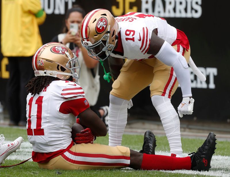 Sep 10, 2023; Pittsburgh, Pennsylvania, USA;  San Francisco 49ers wide receiver Brandon Aiyuk (11) celebrates his touchdown with wide receiver Deebo Samuel (19) against the Pittsburgh Steelers during the first quarter at Acrisure Stadium. Mandatory Credit: Charles LeClaire-USA TODAY Sports