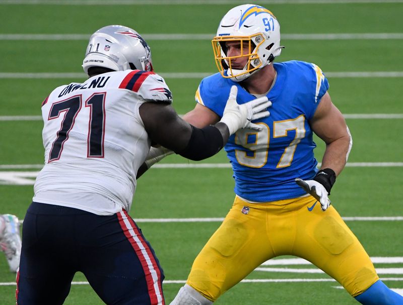 Dec 6, 2020; Inglewood, California, USA; Los Angeles Chargers defensive end Joey Bosa (97) battler New England Patriots offensive tackle Mike Onwenu (71) at the line during the third quarter at SoFi Stadium. Mandatory Credit: Robert Hanashiro-USA TODAY Sports
